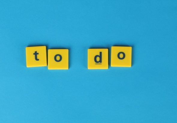 Yellow letter tiles spelling 'to do' against a vibrant blue background for organizational themes.
